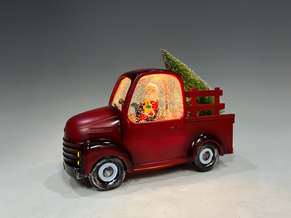 Père Noël dans un vieux camion rouge