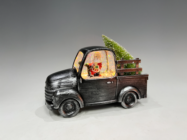 Père Noël dans un camion vintage noir