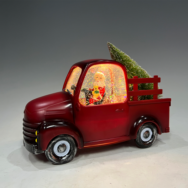 Père Noël dans un vieux camion rouge