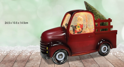 Père Noël dans un vieux camion rouge